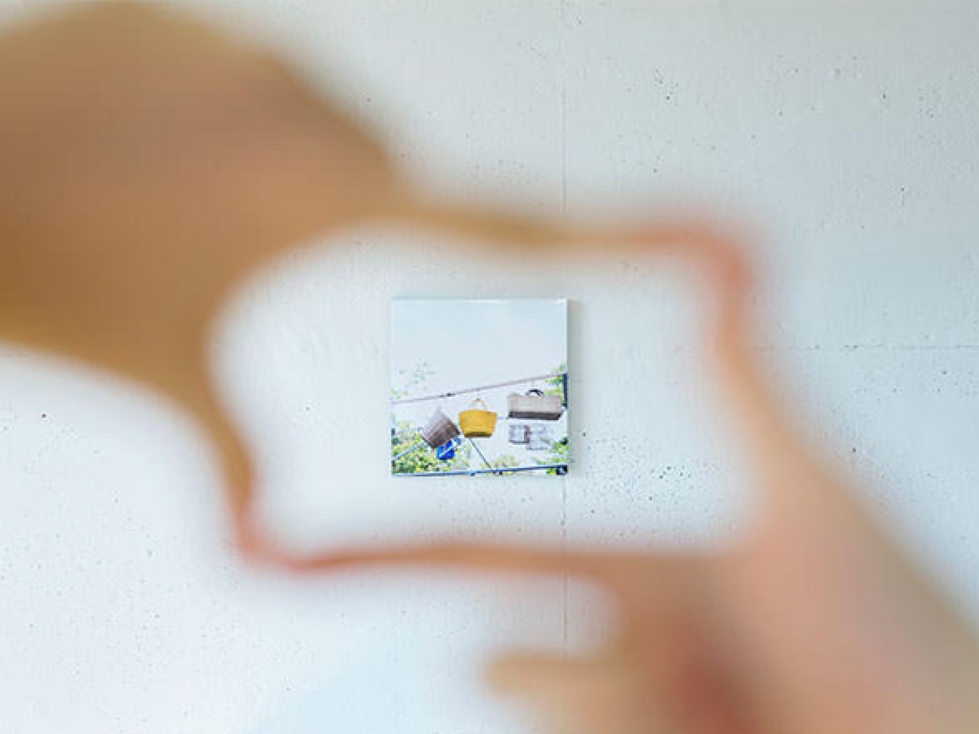 手で形作ったフレーム越しに眺める、壁の小さなWALL DECOR